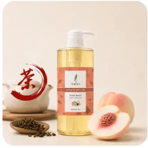 Limited edition Theo10 body wash with an orange label, beside a halved peach and a teapot with a red tea character